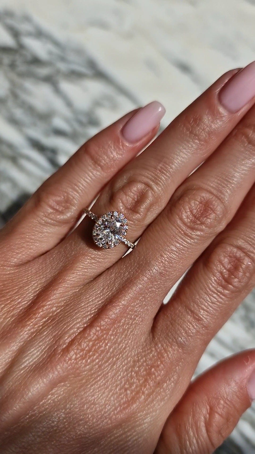 Oval diamond ring on hand, captured March 27, 2023.