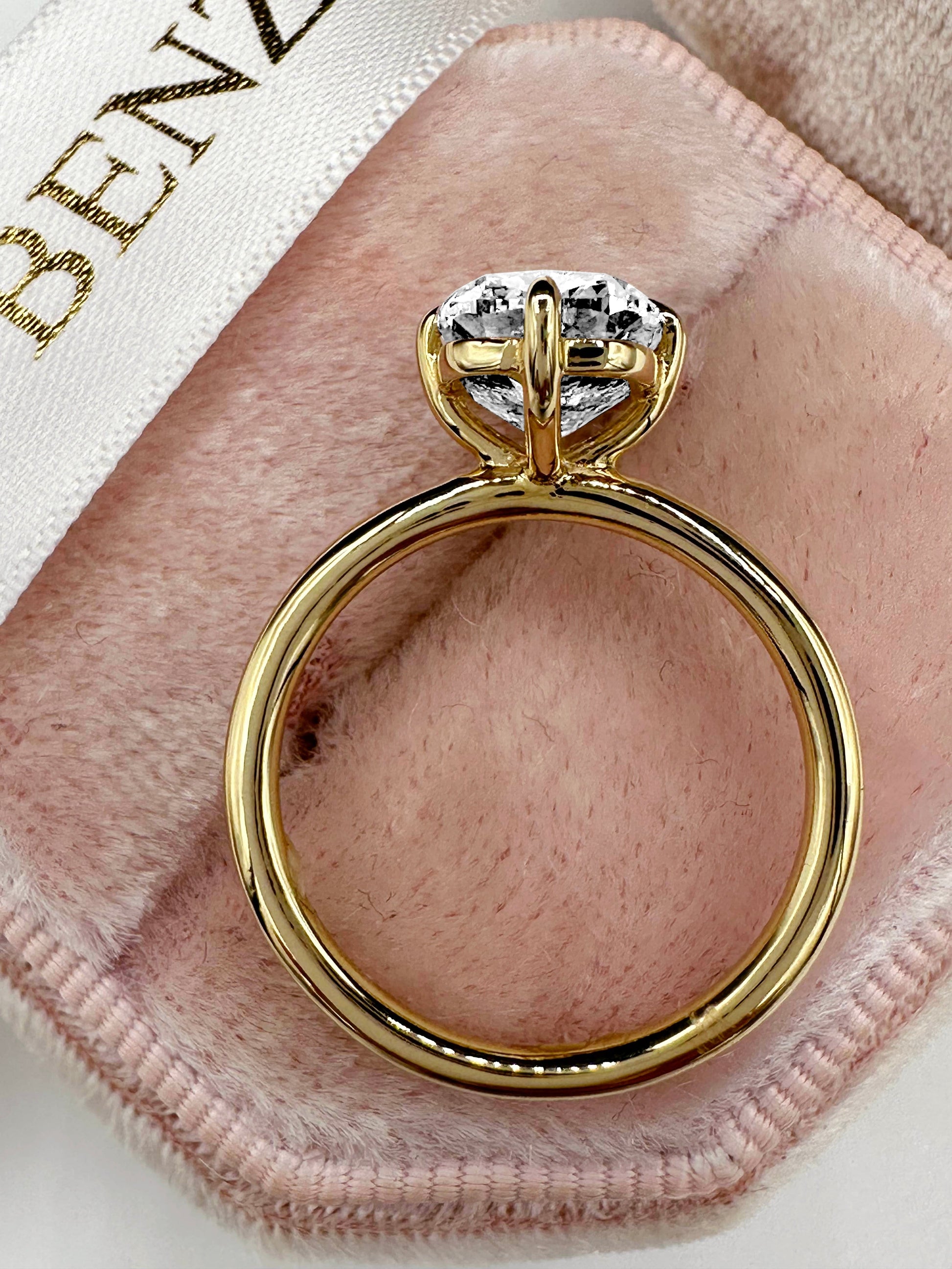 Elongated cushion cut diamond ring in yellow gold with compass setting