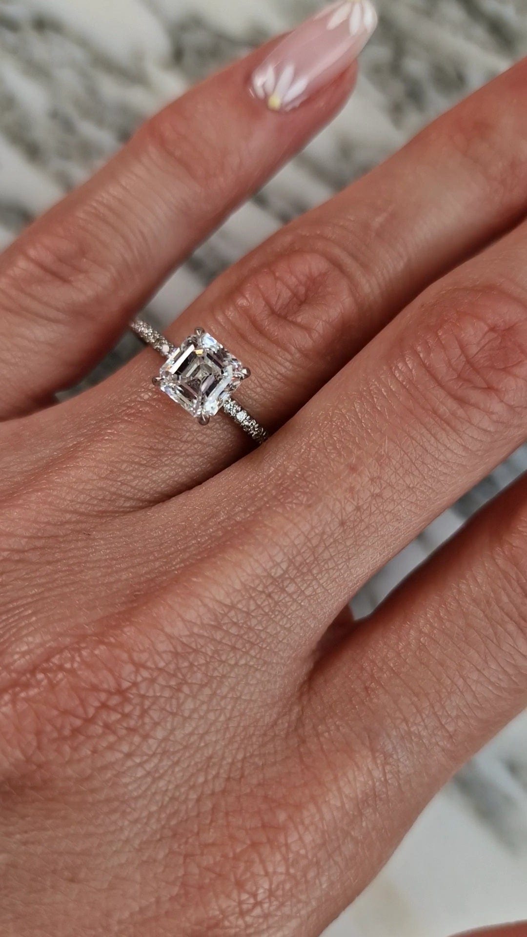 Diamond engagement ring on hand, captured April 20, 2023