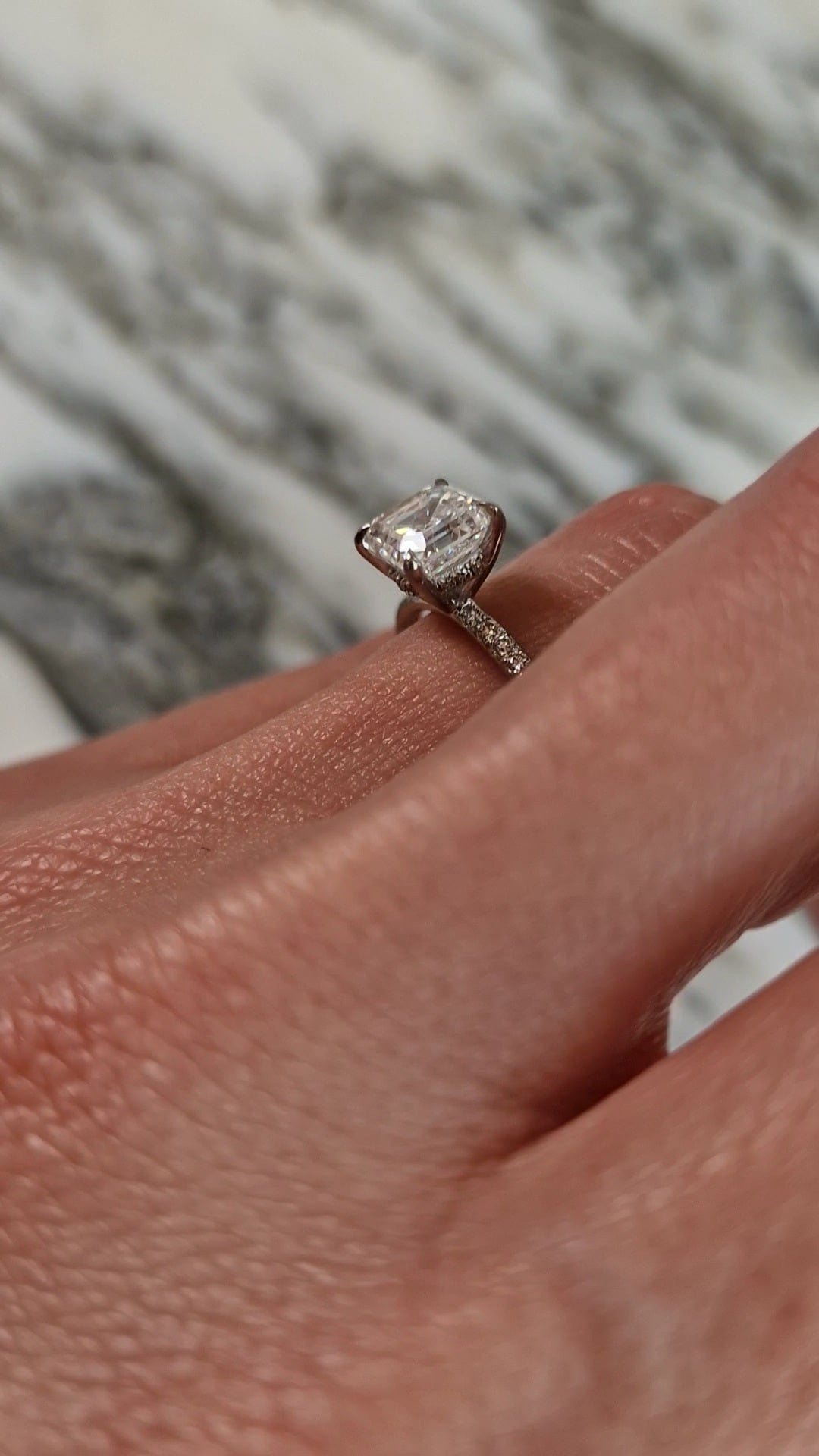 Diamond engagement ring on a finger, captured on April 20, 2023