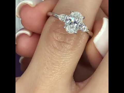 1.30 Carats Oval Cut with Pear Shape Side Stones Diamond Engagement Ring